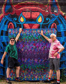 Kaffe Fassett's Quilts in London back book cover  showing Kaffe and Brandon with quilt in front of mural.