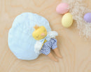 Mini Robin Chick Doll  on wood surface with blue bed and colored eggs