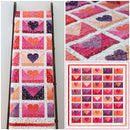Colorful quilt called Ombre Love Letters showing heart patterns displayed on a ladder and flat surface.