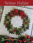 Twister Holiday quilt pattern cover featuring a Christmas wreath design with red and green colors.