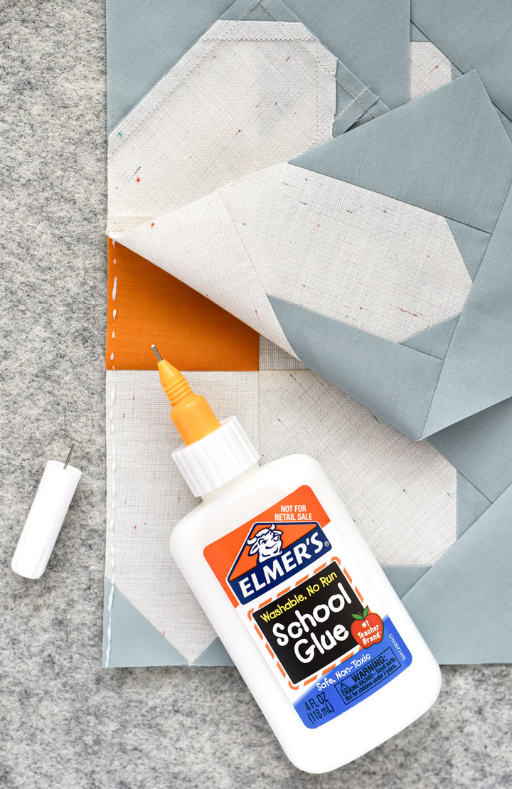 Fineline Glue Applicator Tips shown on elmer's washable glue bottle