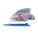 Oliso Mini Project Iron With Solemate Kaffe Fassett showing side of iron above solemate trivet 