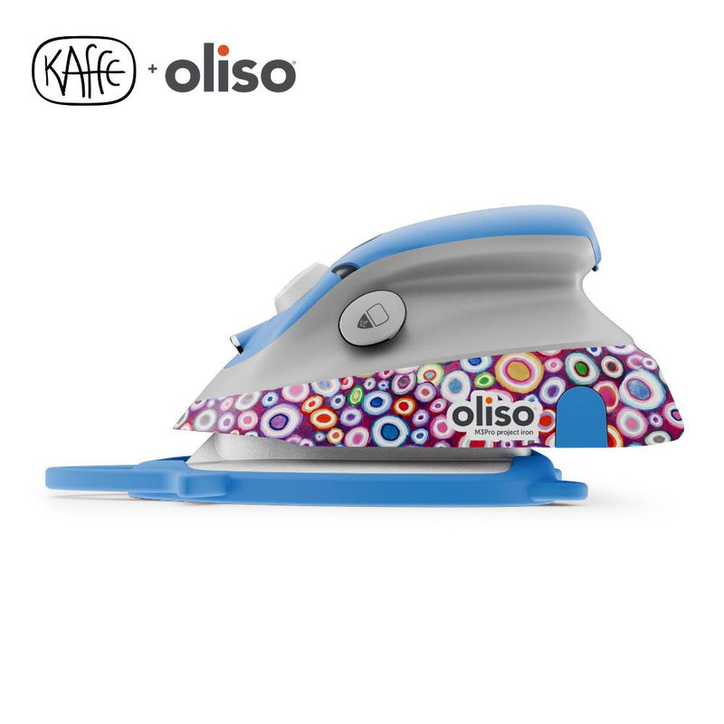 Oliso Mini Project Iron With Solemate Kaffe Fassett showing side of iron with solemate trivet