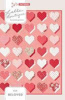 Beloved quilt Patterned shows heart designs on a pink background, featuring the brand 'Lella Boutique'.
