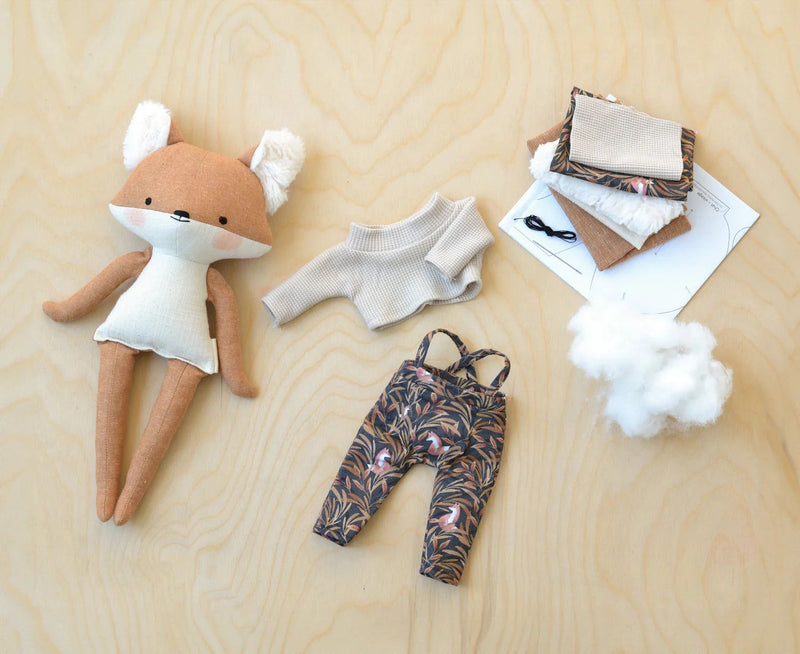 Bernard Fox Doll ensemble on wooden surface