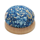 Blue Floral Pincushion with Wooden Base against a white background.