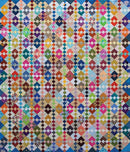 Colorful quilt with geometric pattern from Bonnie Hunter's Scrap-Savvy Quilting