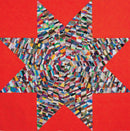 Colorful star-shaped patchwork quilt on red background from Bonnie Hunter's Scrap-Savvy Quilting