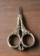 Botanical Garden Scissors in Antique Gold Finish on wooden surface.