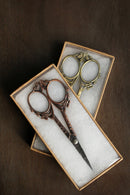 Butterfly Scissors in Antique Finish in gift boxes on wooden surface.