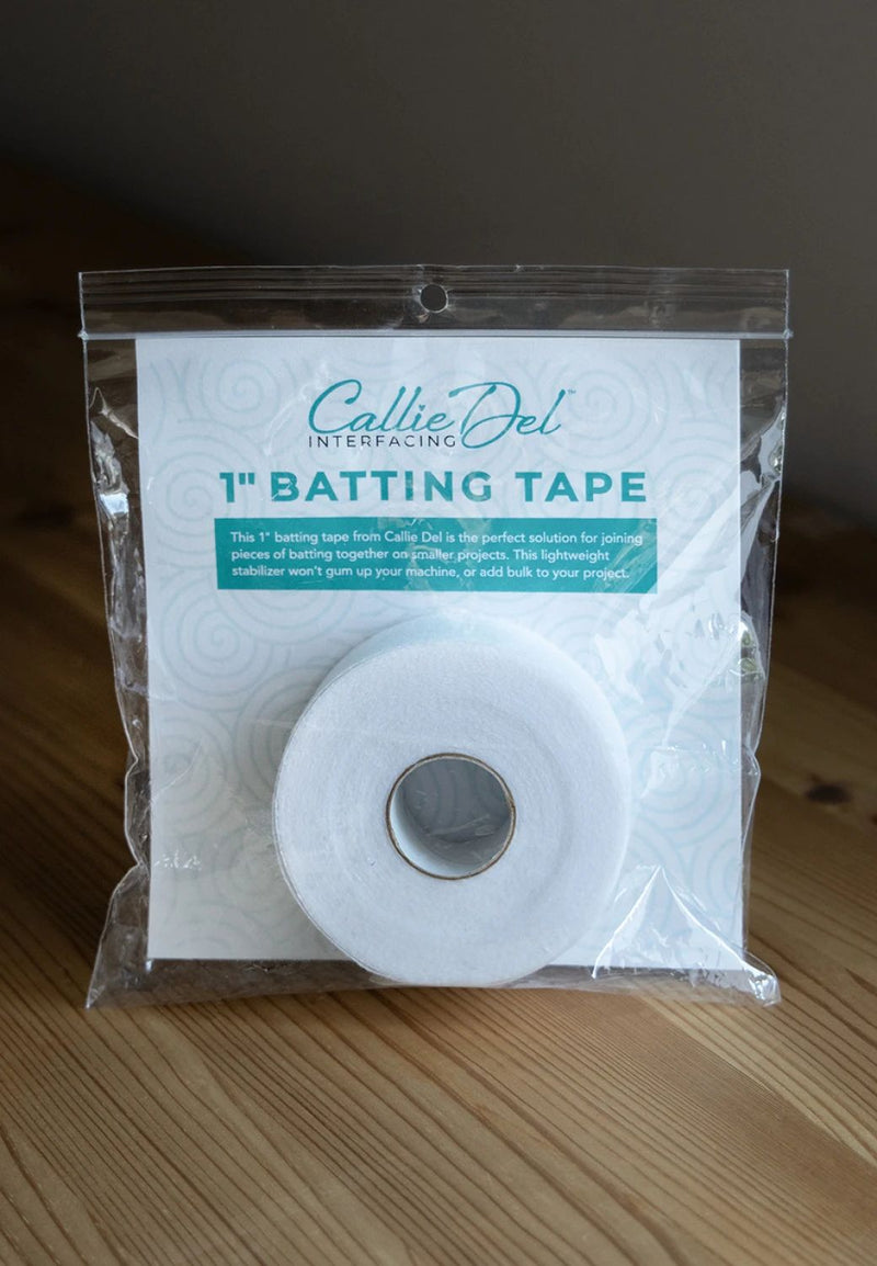 Callie Del Batting Tape - 1 inch x 30 yard roll shown in plastic packaging on wooden grain surface.