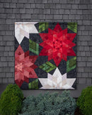 Crimson Christmas quilt shown on wall