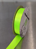 Spool of green ribbon with a label on a shiny urface. Double-Face Satin Ribbon 22mm (.875") Wide