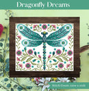 Dragonfly Dreams Cross Stitch Pattern of a dragonfly with flowers shown on a wooden surface, surrounded by floral elements.