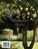 Garden scene with trees and plants, featuring a dedication message on back of book cover for Gathered - Quilt Recipes 2.