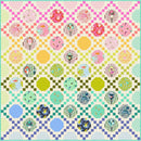 Happy Habitat Free PDF Quilt with geometric pattern on a checkered background.