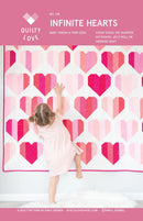 Infinite Hearts Quilt pattern with heart designs featuring a child reaching towards it, on a pink background.