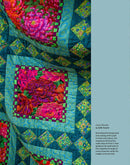 A close-up of a colorful quilt with floral patches and geometric borders, shown alongside a light blue text panel on the right with the caption 'Cool Florals by Kaffe Fassett'.  From the book, "Kaffe Fassett's Quilts at an English Manor House".