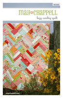 Quilt pattern book titled 'Lazy Sunday Quilt' by May Chappell with a colorful quilt displayed outdoors.