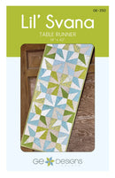 Quilted table runner with geometric pattern on a wooden surface, branded 'Lil' Svana' by GE Designs.