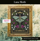 Luna Moth Cross Stitch Pattern shown stitched in frame on wallpapered wall