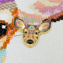 Mandala Deer Enamel Needle Minder on matching cross-stitch design.
