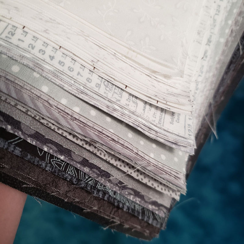 Many Shades of Grey Ten Inch Squares Quilting cottons shown close up