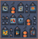 Neighborhood Views Quilt Kit shows a quilt with houses with ravens and pumpkins on a dark blue background.