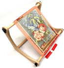 Nurge Lap or Table Stitchery Stand with floral needlepoint canvas on a white background.