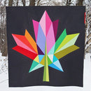 Oh Canada! Wondergarden colorful geometric leaf design quilt against a snowy background
