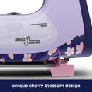 Oliso Pro Plus Smart Iron Yaya Han Purple and pink iron with cherry blossom design on a white background