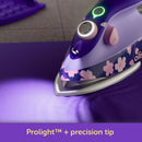 Oliso Mini Project Iron With Solemate Yaya Han iron with floral design on a purple fabric, featuring Oliso branding.