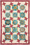 Quilt with geometric pattern featuring blue and orange designs on a red border from Panel Perfect 3-Yard Quilts.