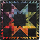 Prismic Star Flannel Quilt Kit store sample has large star in multiple colors on charcoal background.