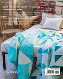 Back cover of "Quilts in Modern Color" showing teal and white quilt on a bed with a chair and brick wall in the background, featuring text about quilt patterns.
