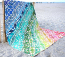 Rainbow Waves  Quilt on beach with rainbow colors.
