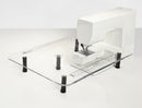 White sewing machine on a Sew Steady Custom Large Extension Table with black feet on a white background