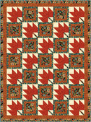 Quilt with geometric pattern featuring red, white, and blue colors on a brown background from the Step it Up with 5-Yard Quilts book.