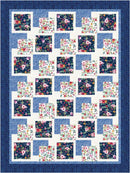 Quilt with floral square patterns on a blue background from the Step it Up with 5-Yard Quilts book.
