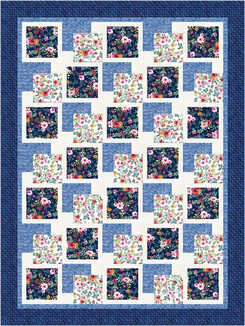 Quilt with floral square patterns on a blue background from the Step it Up with 5-Yard Quilts book.