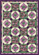 Quilt with floral pattern in purple, green, and pink on a purple border from the Step it Up with 5-Yard Quilts book.