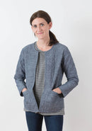 Woman wearing a blue quilted Tamarack jacket on a white background