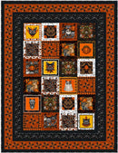 The Spooky Bunch Free PDF Quilt Pattern picture shows Halloween-themed patchwork quilt with various cat illustrations on a black background.