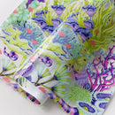 Tula Pink Floral Reef What You Sew Half Yard Cut Vinyl has colorful coral and sea anemone pattern on a clear background.