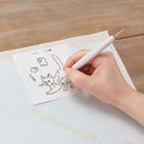 Person using the Water Erasable Tracing Paper with a cat design.