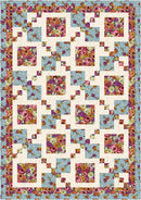 Floral quilt with a geometric pattern on a blue background from Weekend 3-Yard Quilts