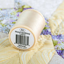 YLI Hand Quilting Thread 40 wt  3-ply 457 m (500 yd.) spool - Natural 001 showing bottom of spool
